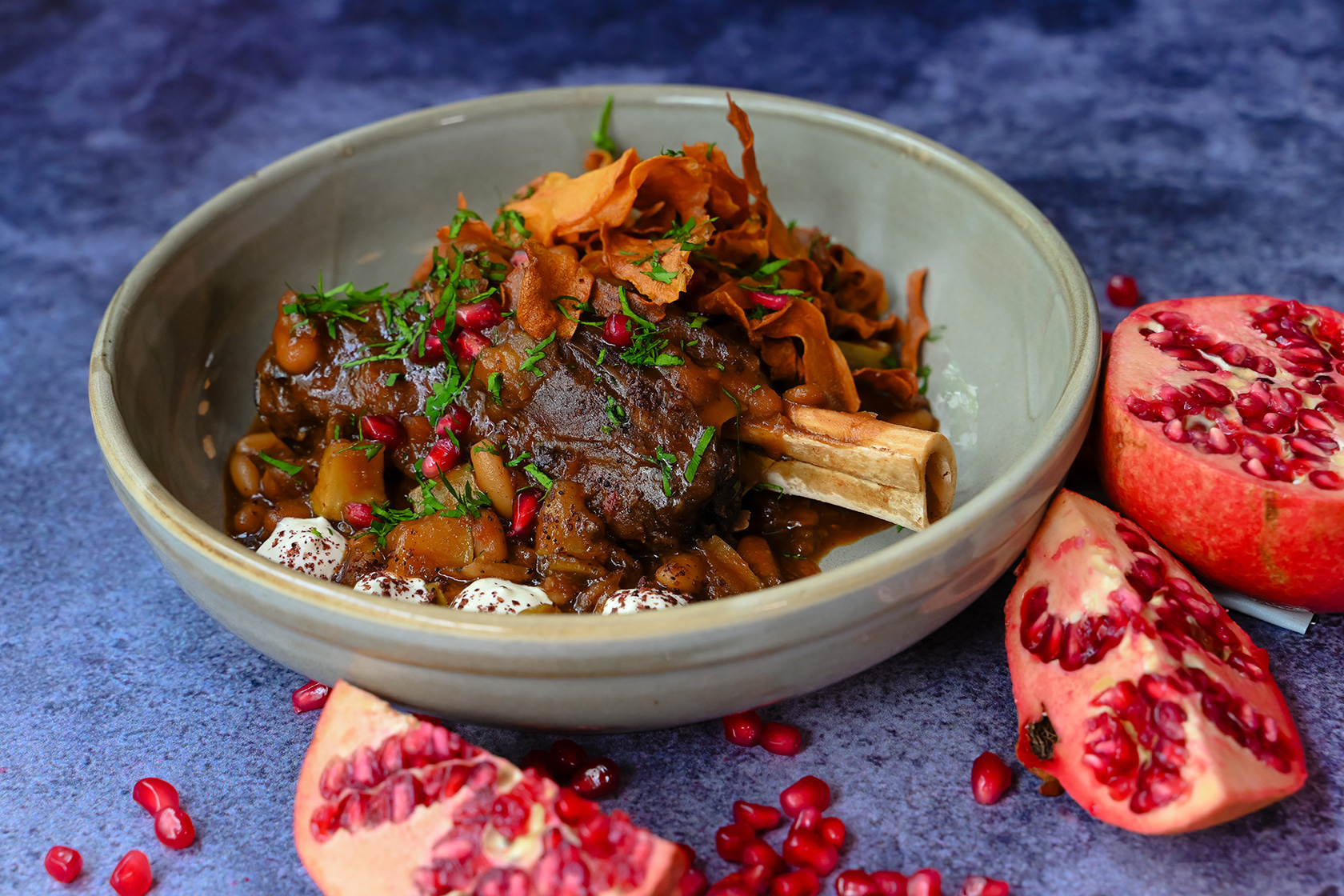Lamb shank dish garnished with pomegranate and herbs at ORSO in Cork